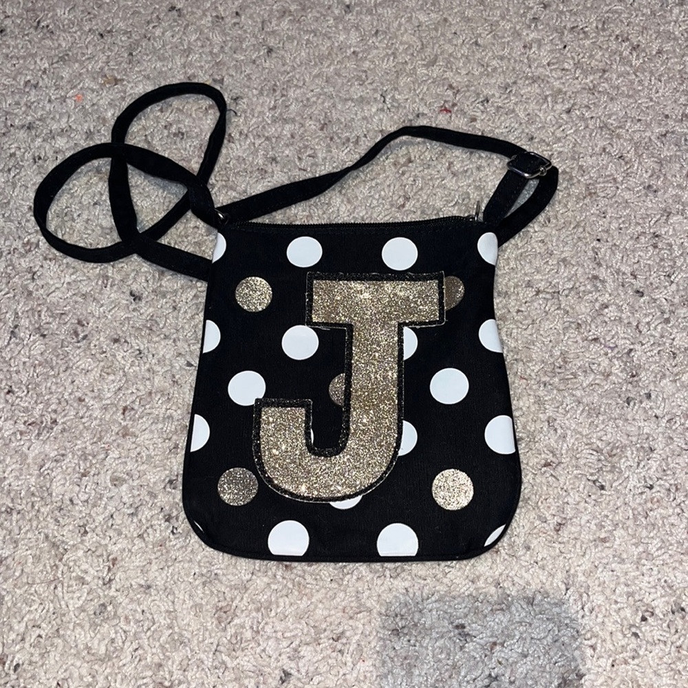 Justice bag with the letter “J” on it. Cross body, gold and white polka dots